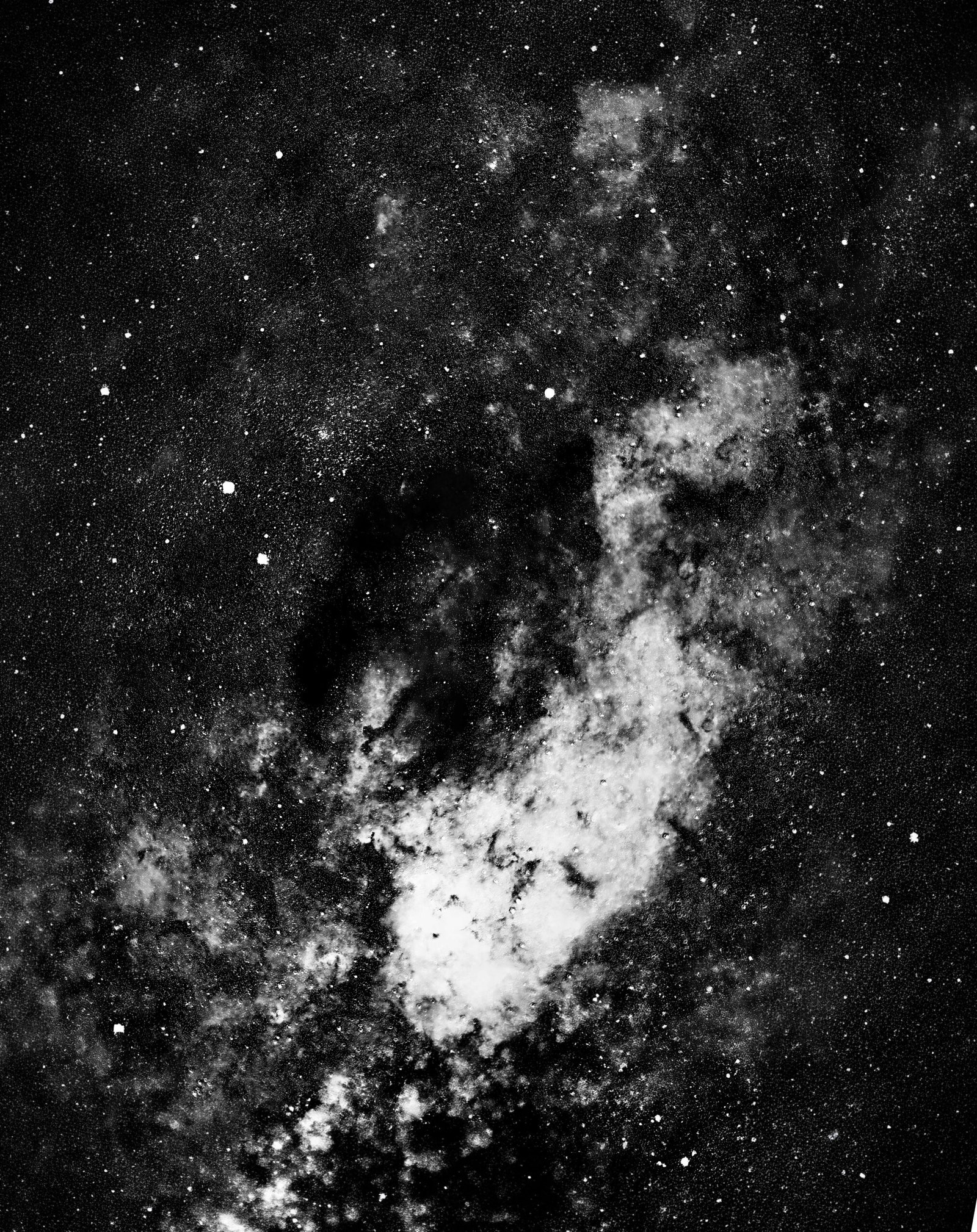 The silhouette of the southern skies. The Coalsack Nebula is the most prominent dark nebula in the sky. Resting nearly 600 light-years away, this massive cloud of cold interstellar dust completely absorbs the light from the dense background starfields of the Milky Way, creating a striking cosmic void.