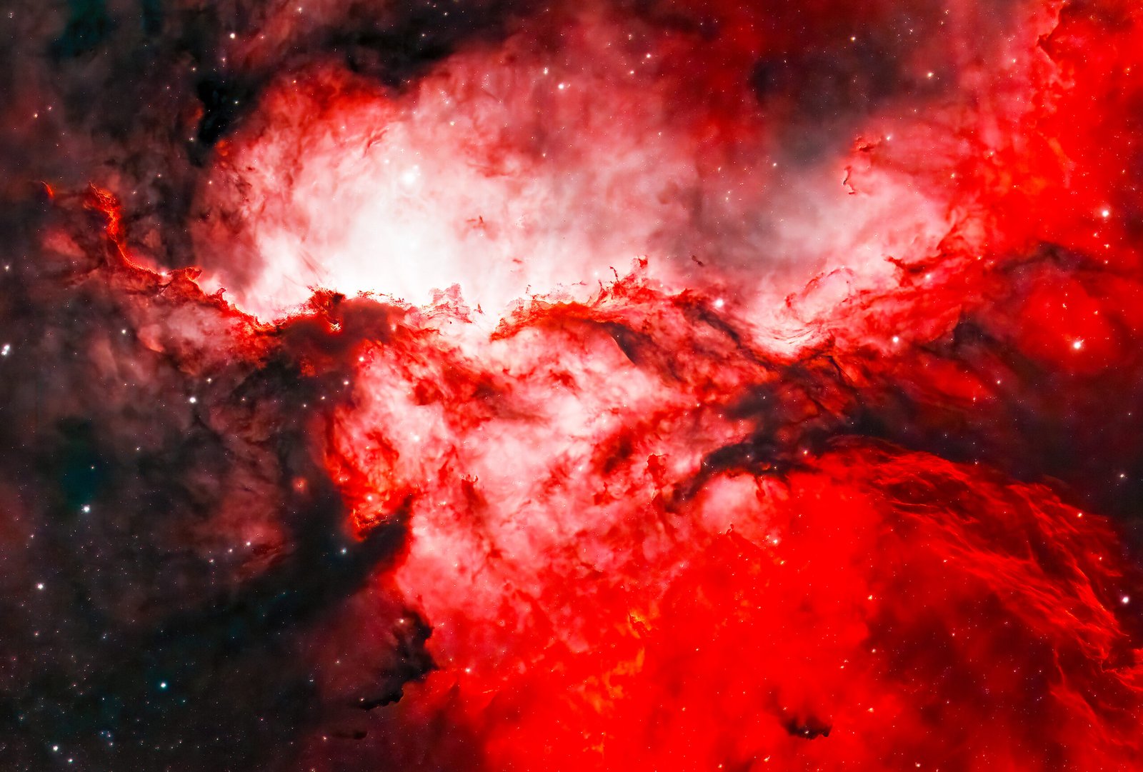 Fighting Dragons of Ara: NGC 6188 is located 4,000 lightyears from Earth. The “dragons” are made up of thick, dark dust clouds that appear black, but also lighter dust clouds that glow in red due to ionized hydrogen, caused by the energetic outflows from hot, young stars.