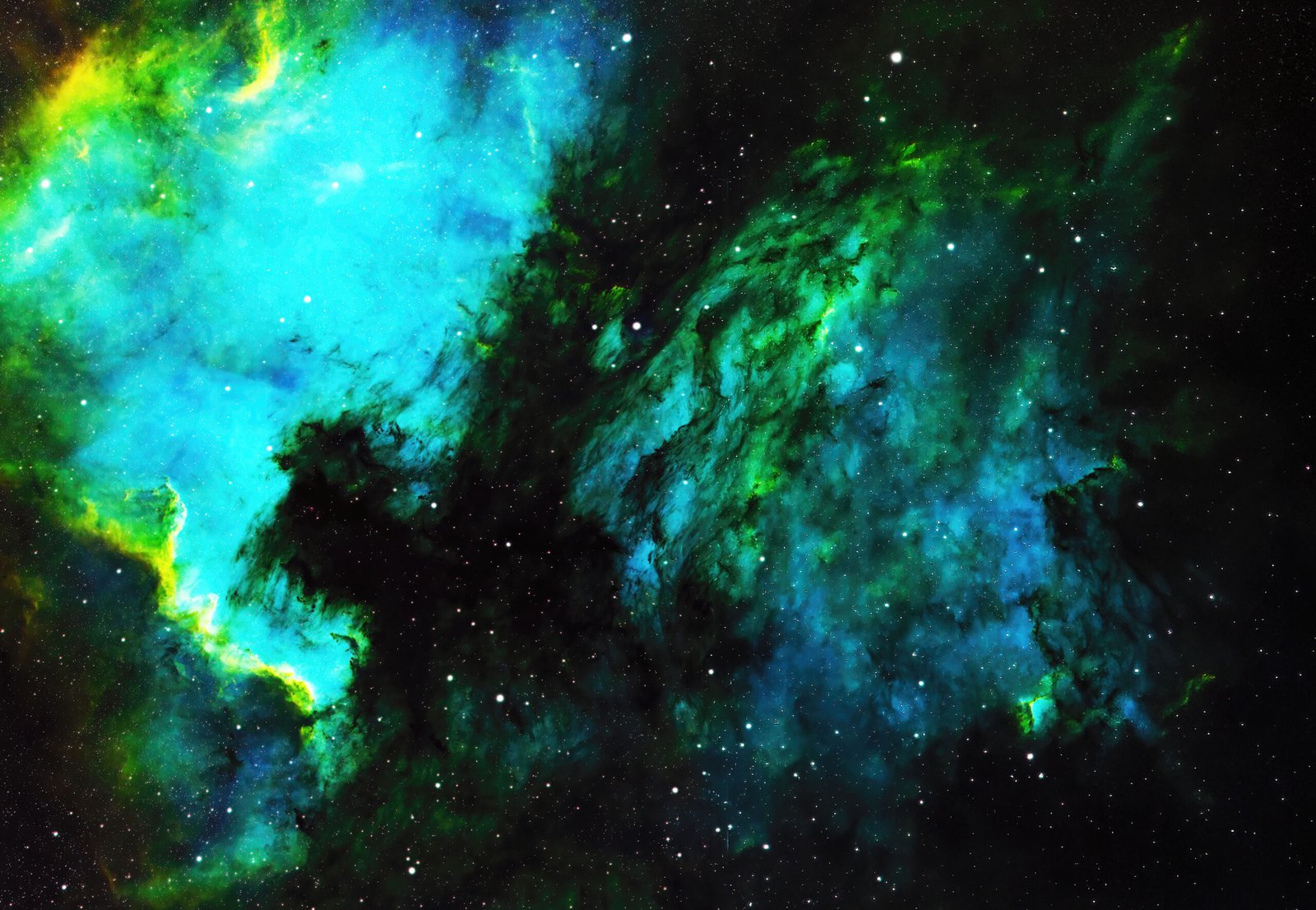 Located approximately 1,800 light-years away, the Pelican Nebula (IC 5070) is an active cosmic nursery separated from its larger neighbour, the North America Nebula, by a dense lane of obscuring dark dust. This framing beautifully captures the ionization fronts and gas filaments that give the nebula its distinct, bird-like silhouette.