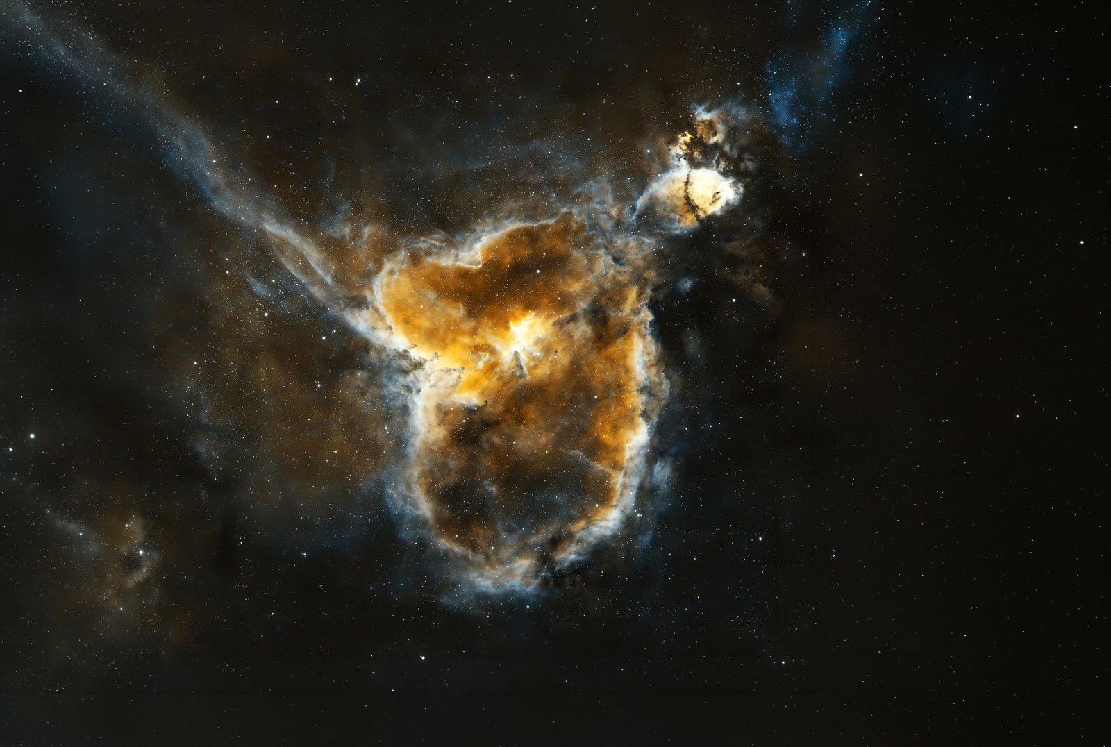 IC 1805, commonly known as the Heart Nebula, is a massive emission nebula located 7,500 light-distant. Whilst it reveals a distinct heart shape, other orientations mimic the profile of a running dog. The nebula spans roughly 200 light-years and glows intensely due to ionized hydrogen gas energized by Melotte 15, a central open cluster of hot, massive newborn stars.