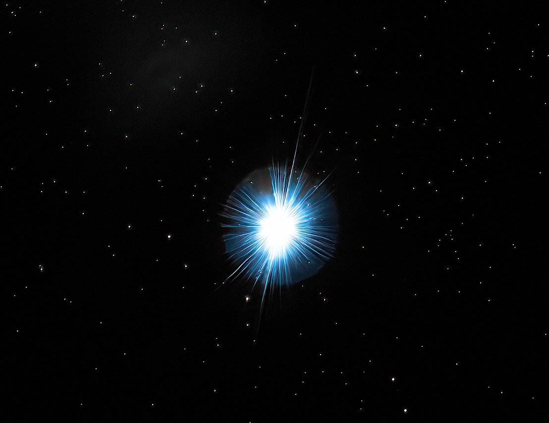 Sirius is the brightest star in the night sky, located 8.6 light-years distant. It shines with an apparent magnitude of -1.46, making it twice as bright as any other star visible. Its intense, blue-white luminosity stems from its high surface temperature of approximately 9,940 Kelvin and its classification as a main-sequence star.
